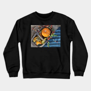 A basket of pumpkins in the fall season with fall decoration. Crewneck Sweatshirt